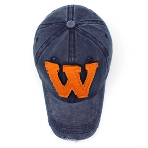 Macro detail of navy blue washed cotton baseball cap with orange letter W embroidery
