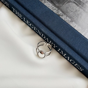 Detailed view of an adjustable minimalist 925 sterling silver matte round signet ring