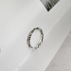 Detail of vintage 925 sterling silver knotted ring with antique textured finish
