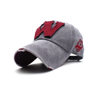 Detailed macro view of retro washed grey cotton fabric with red 3D letter W embroidery