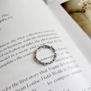 Detailed macro view of vintage 925 silver knotted ring on antique book pages