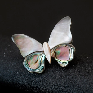 Vintage butterfly brooch featuring white mother of pearl and colorful abalone shell wings