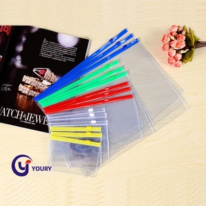 Transparent PVC zipper bags in various sizes with colorful slide seals on wood surface