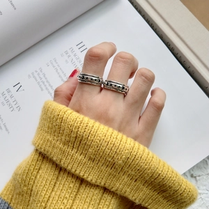 Close-up of vintage 925 sterling silver star and moon spinner rings worn on fingers