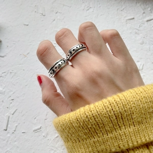 Detail of 925 sterling silver spinning ring featuring hollow star and moon patterns