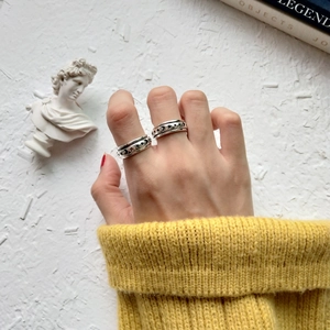 Detail of vintage 925 sterling silver rings with celestial moon and star relief patterns