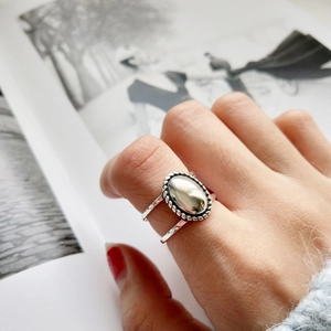 Macro detail of retro 925 sterling silver ring with oval centerpiece and twisted rope edge