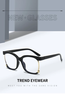 Detail of black and gold mixed-material eyewear frame with blue light blocking lenses