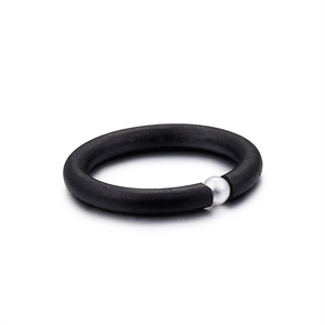 Minimalist black matte ring with a white pearl accent shown from a top-down view