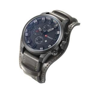 Detail of CURREN men's watch featuring a black dial, calendar window and grey leather strap