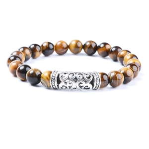 Tiger eye beads bracelet with silver hollow lion head charms on a clean white background