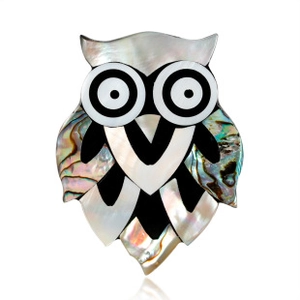 Detail of owl brooch inlaid with colorful abalone and mother of pearl on white background
