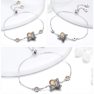 Detailed views of a silver bee bracelet with adjustable slider and honeycomb charm