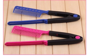 Detail of pink and blue V-shaped hair straightening combs on a wooden background