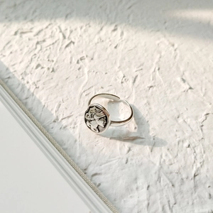 Macro shot of silver vintage portrait relief on adjustable 925 sterling silver ring