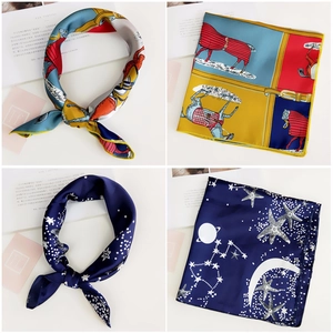 Detail view of equestrian horse print and celestial star pattern silk neck scarves