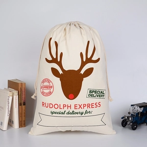 Macro detail of canvas Christmas gift bag featuring reindeer print and red drawstring
