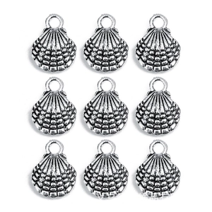 Macro view of nine silver alloy seashell charms with textured surface and top hanging rings