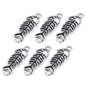 Detail view of six silver-colored fishbone alloy charms with double loops for DIY jewelry