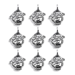 Detailed view of silver alloy fish charms with textured scales and round hanging loops