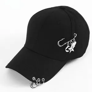 Detail of black cotton baseball cap with silver metal rings and hanging celestial charms