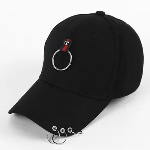Detail of black baseball cap featuring iconic red and green stripe with silver metal rings
