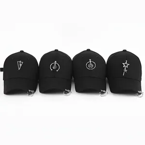 Set of four black cotton baseball caps with trendy silver metal rings and unique pendants
