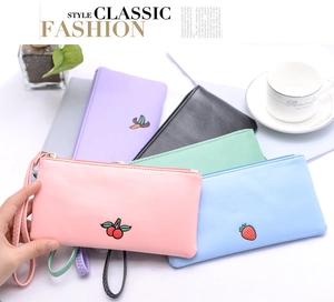 Detailed macro view of colorful PU leather wallets with elegant fruit embroidery designs