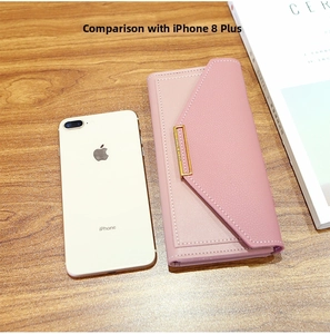 Pink lychee texture long wallet next to a phone showing the slim envelope size
