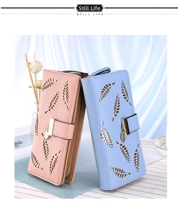Detail of pink and blue long wallets with leaf hollow-out design and metal pendant