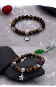 Close-up of natural tiger eye beads bracelet with silver star and hexagram charms