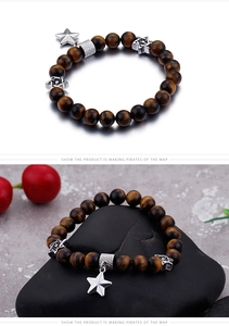 Macro shot of tiger eye beaded bracelet featuring silver star charms and hexagram beads
