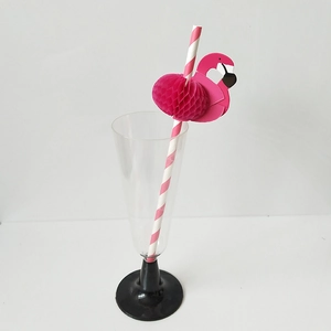 Detailed view of pink striped paper straw with a flamingo honeycomb decoration in a glass
