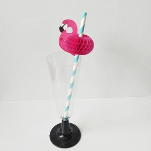 Detailed view of blue striped paper straw with a pink honeycomb flamingo decoration