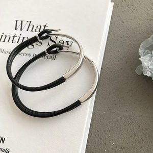 Detail of minimalist black leather cord and silver metallic splicing couple bracelets