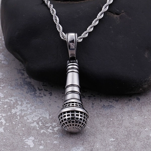 Silver microphone pendant necklace with twist chain for men on dark rock background