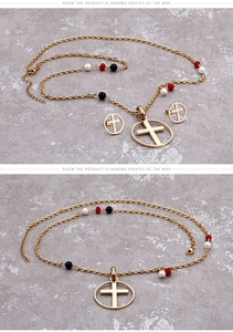 Detail of gold cross pendant necklace and matching earrings with colorful beads