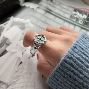 Detail of vintage 925 sterling silver gothic cross ring with black zircons on finger