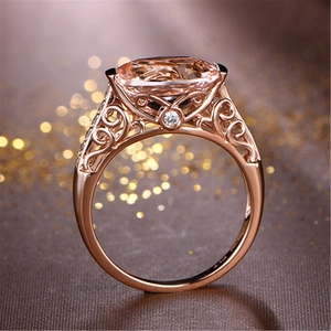 Elegant 18K rose gold ring featuring a large oval morganite gemstone and diamond accents
