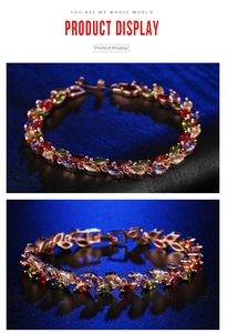 Detail view of colorful marquise-cut crystal bracelet with rose gold claw setting on velvet