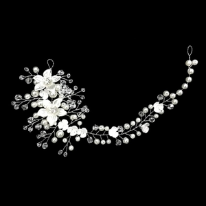 Macro detail of bridal hair vine with silver wire flowers, pearls and crystals