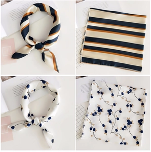 Detail of square silk scarves with striped and floral prints featuring fine rolled edges