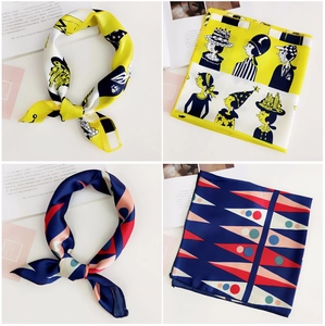 Detail showing printed silk square scarves with character illustration and geometric patterns