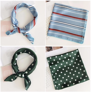 Detail of square silk scarves with classic blue stripes and green polka dot patterns