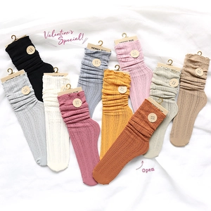 Detailed knit cable pattern and lettuce edge trim on various colored slouch socks