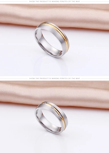 Macro shot of two-tone stainless steel rings with brushed finish and three set diamonds