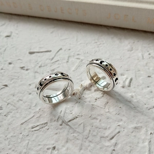 Minimalist 925 sterling silver spinning rings with celestial star and moon relief motifs