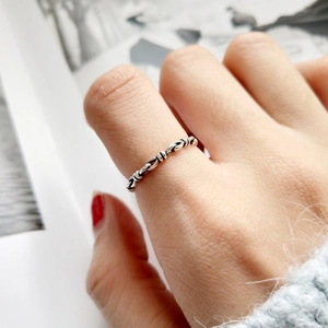 Vintage 925 sterling silver knotted rope ring on model with soft blue sweater
