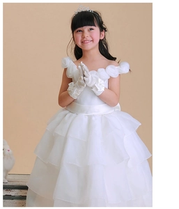 Close-up of a white princess dress with layered cake skirt and 3D floral neckline