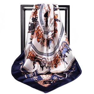 Close-up of a 90cm square satin scarf featuring vintage paisley and carriage patterns